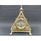 A VICTORIAN BRASS GOTHIC REVIVAL MANTLE CLOCK DESIGNED BY BRUCE TALBERT, TRIANGULAR FORM WITH