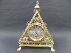 A VICTORIAN BRASS GOTHIC REVIVAL MANTLE CLOCK DESIGNED BY BRUCE TALBERT, TRIANGULAR FORM WITH