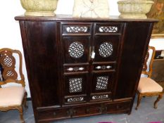 A CHINESE CARVED COURT CUPBOARD WITH TWIN PANELLED PIERCED DOORS ABOVE THREE BASE DRAWERS. 170CM
