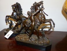 AFTER COUSTOU, A PAIR OF MARLEY HORSE FIGURAL GROUPS. BRONZE ON CONFORMING BLACK SLATE BASES. OVER