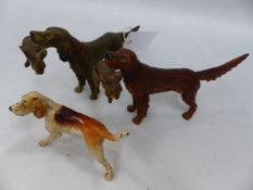 THREE COLD PAINTED BRONZE FIGURES OF DOGS, TWO HUNTING DOGS WITH RABBITS AND A FOX HOUND