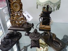 AN ANTIQUE BRONZE CLOCK ON FOLIATE AND DOG DECORATED SUPPORTS WITH PLINTH BASE. 28CM HIGH, A