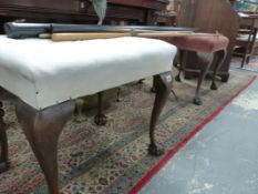 A PAIR OF GEORGIAN STYLE DRESSING STOOLS ON CABRIOLE LEGS WITH CLAW AND BALL FEET.