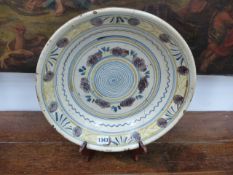 A CONTINENTAL FAIENCE DEP DISH WITH POLYCHROME GEOMETRIC BANDING. D.37cms