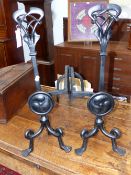 A PAIR OF ART NOUVEAU LIBERTY WROUGHT IRON ANDIRONS INTERTWINED PIERCED KNOPS, SHAFTS WITH ROUNDELS.