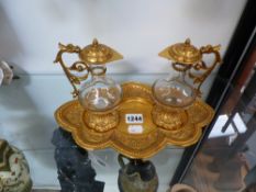 A VICTORIAN GILT METAL TWIN CARAFE COMMUNION SET, SHAPED STAND WITH DRAGON DECORATED BORDER.