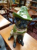 AN UNUSUAL CONTINENTAL POTTERY FIGURE OF A SEATED PUG DOG IN FANCY DRESS, POLYCHROME AND GILT