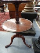 AN ANTIQUE MAHOGANY TWO TIER DUMB WAITER ON TRIPOD SUPPORT.