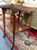 A PAIR OF MAHOGANY EMPIRE STYLE END TABLES WITH TOOLED LEATHER TOPS OVER OVAL FLUTED LEGS UNITED