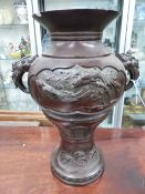 A PAIR OF ORIENTAL BRONZE TWIN HANDLE BALUSTER VASES. SHAPED RELIEF PANELS OF BIRDS. 44CM HIGH