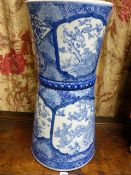 A JAPANESE BLUE AND WHITE PATERED CONICAL UMBRELLA/STICKSTAND WITH PANELS OF BIRDS AMIDST FOLIAGE.