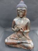 AN ORIENTAL BRONZE FIGURE OF A BUDDHA. RETAINS SOME POLYCHROME DECORATION AND TRACES OF GILDING.