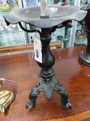 AN UNUSUAL ORIENTAL BRONZE PRICKET CANDLESTICK ADAPTED AS A LAMP, LOTUS FORM WITH TRIFID MASK