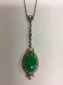 A circa 1930's 18ct and platinum jade set oval pendant with diamond surround and diamond set