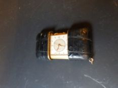 A Swiss Movado leather cased travelling alarm watch, Eameto model and inscribed on reverse