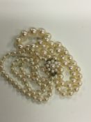Two graduated cultured pearl necklaces, one having a cluster pearl 9ct gold clasp (2)