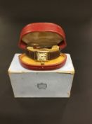 A gentleman's Cartier wristwatch with leather strap and precious metal clasp. Gem set winder. No