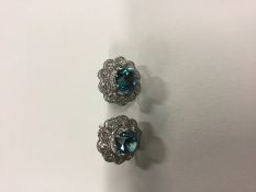 A pair of ladies blue zircon and diamond cluster earrings. 1.25cm diameter