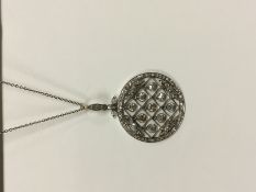 A Belle Epoch diamond set circle brooch with diamond set suspender, the centre set with nine diamond