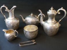 A silver six piece tea set designed in the Indian style comprising teapot, hot water pot, coffee