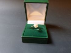 A gold cultured pearl and diamond cluster ring.