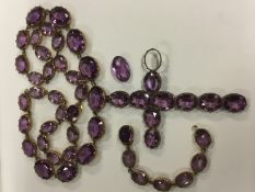 A 19th Century amethyst paste set cross pendant on necklace, approximately 33cm long together with a