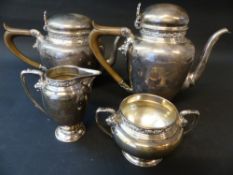 A silver four piece tea set comprising teapot, hot water pot, cream jug, sugar bowl. London 1930.