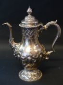 A George Il silver coffee pot with later decoration. London 1763. Weight 35ozs. 30cm high