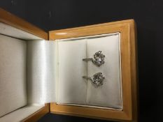 A pair of single stone brilliant cut diamond earstuds, approximately 1 carat each.