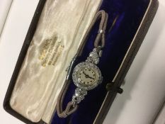 A ladies diamond set cocktail watch the case stamped platinum.