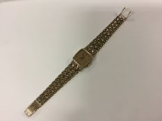 A ladies 9ct gold Omega wrist watch on pierced bracelet. Total weight 32.2grams