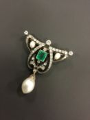 A Belle Epoche diamond and emerald openwork brooch set with centre baguette cut emerald with natural