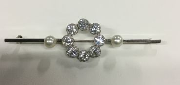 A circa 1920's 18ct and platimun diamond cultured pearl bar brooch set with a circle of eight