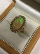 An 18ct gold and platinum set opal and diamond cluster ring