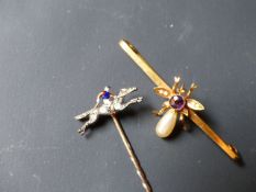 A late 19th Century gentleman's stick pin in the form of a diamond set racing horse with enamel