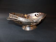 An Art Nouveau silver swing handled fruit basket on oval pedestal foot. Chester 1907. Makers