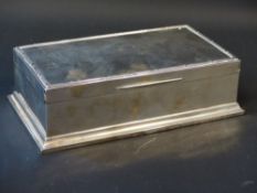 A silver rectangular bridge box with fitted green leather interior dated London 1926, makers