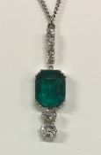 A circa 1930's emerald and diamond pendant suspended from four small diamonds with a further two