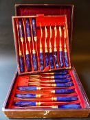 An early Victorian cased set of twelve silver gilt tea knives and forks with lapis and adventurine