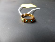 An 18ct gold buckle ring set with turquoise.