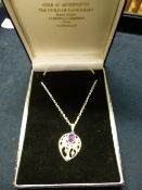 A GUILD OF HANDICRAFT AMETHYST AND SEED PEARL SET OPENWORK PENDANT ON CHAIN. LONDON 2001