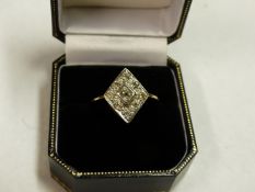 AN ALL DIAMOND SET LOZENGE SHAPED DRESS RING. SIZE Q