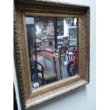 AN ANTIQUE GILT MIRROR