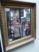 AN ANTIQUE GILT MIRROR