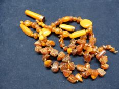 TWO AMBER PART NECKLACES ETC. APPROXIMATELY 90 GRAMS