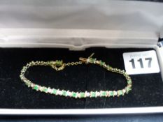 A DIAMOND AND EMERALD TENNIS BRACELET