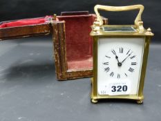 A CARRIAGE CLOCK IN LEATHER TRAVEL CASE