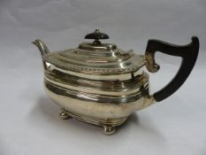 A SILVER TEAPOT WITH GADROON RIM, EBONY HANDLE AND FINIAL. SHEFFIELD 1931. 22 OZS ALL IN