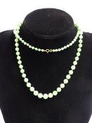 A GRADUATED JADE BEAD NECKLACE. 80CM LONG