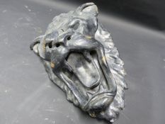 A CAST IRON DOOR KNOCKER IN THE UNUSUAL FORM OF A LION MASK
